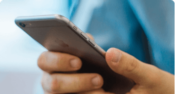 Person using mobile phone to send SMS