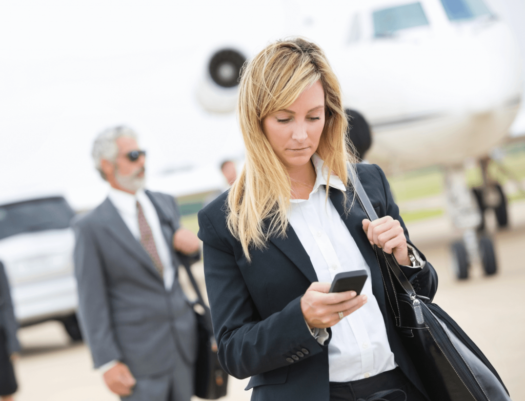 woman walking and watching her phone